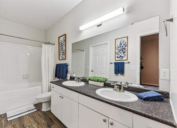 A bathroom with a white tub, sink, and toilet. at Stone Oak @ Parmer, Austin, 78727