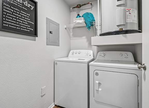 A white dryer and washer in a small laundry room.