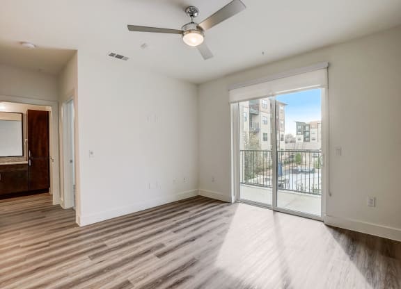 a living room with a large window and a ceiling fan at Aurora Watson Branch, Mansfield, TX