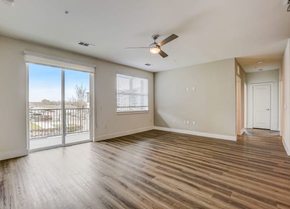 an empty living room with a balcony and a ceiling fan at Aurora Watson Branch, Texas, 76063
