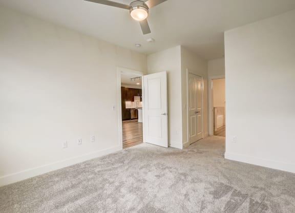 an empty living room with carpet and a ceiling fan at Aurora Watson Branch, Texas, 76063