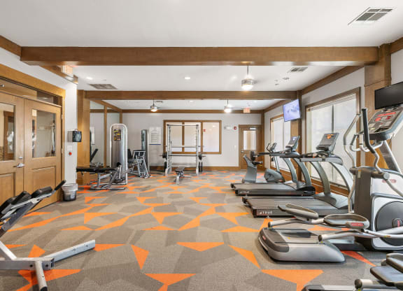a gym with treadmills and other exercise equipment in a room at Lakeline East Apartments, Cedar Park, TX
