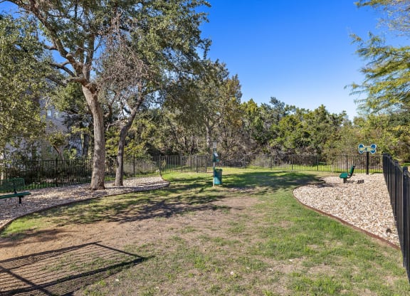 a dog park with trees and a fence at Sonterra Apartment Homes, Austin, TX