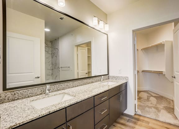 a bathroom with granite counter tops and a large mirror at Aurora Watson Branch, Texas, 76063
