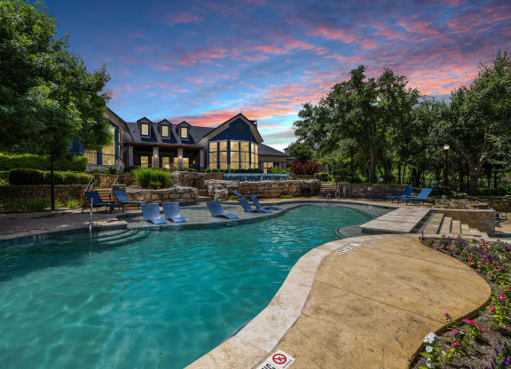 a swimming pool with a house in the background at sunset at The Vista on Brodie, Texas, 78745