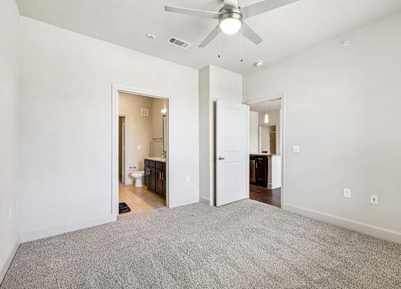 A room with a ceiling fan and carpeted floor.at North Creek, Hutto, TX