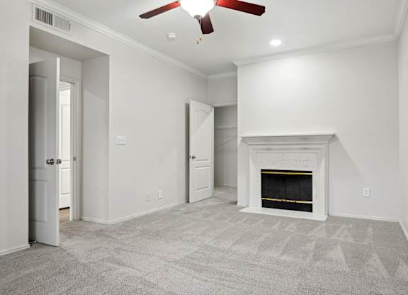 A room with a fireplace and a ceiling fan.