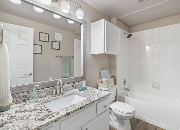 a bathroom with a sink and a toilet and a tub at Sonterra Apartment Homes, Austin, Texas