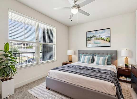 A bedroom with a large bed and a ceiling fan. at North Creek, Texas, 78634