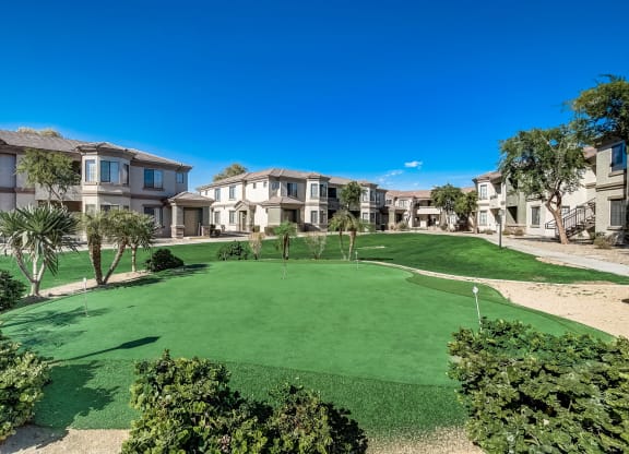 a putting green in the middle of an apartment complex  at Adiamo Palm Valley, Goodyear, AZ