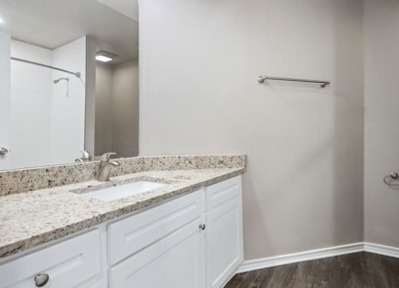 A bathroom with a mirror at Waters Edge Apartment Homes, Texas, 78626