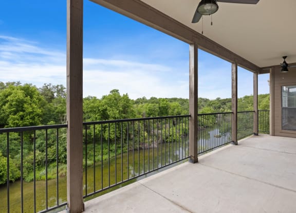 A large balcony with a view of a body of water at Waters Edge Apartment Homes, Georgetown, TX