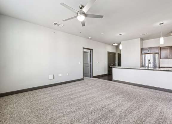 A room with a ceiling fan and carpeted floor.at North Creek, Hutto, TX, 78634