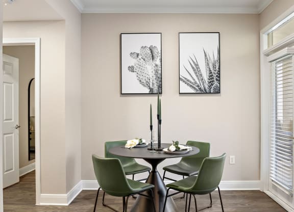 a dining room with a table and chairs and two pictures on the wall at The Verandah, Austin, Texas