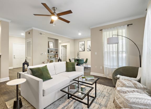 a living room with a white couch and a ceiling fan at The Verandah, Austin, Texas