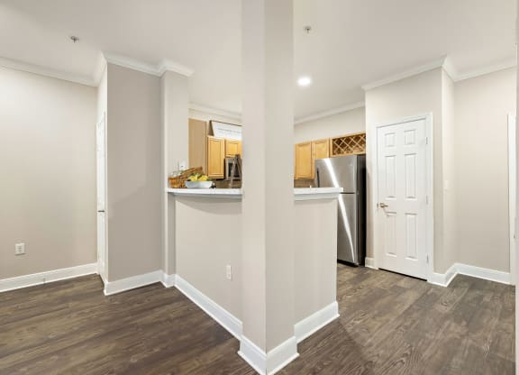 a renovated kitchen and living room with a refrigerator and a door at The Verandah, Texas, 78726