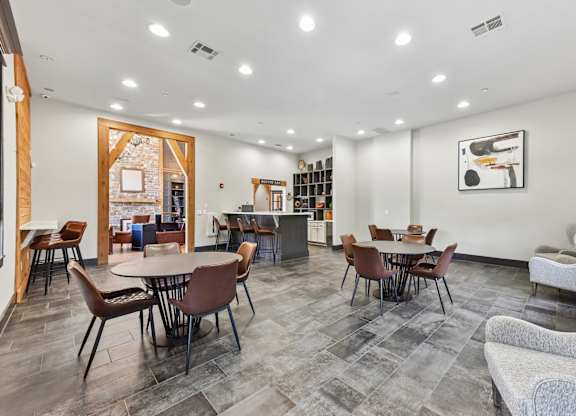 A spacious room with a dining table and chairs.