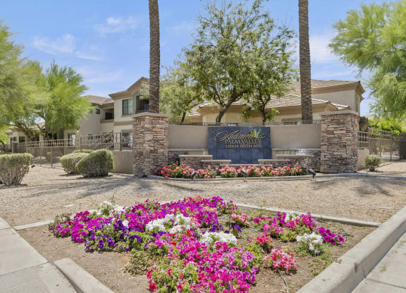 a garden with flowers and trees in front of a house  at Adiamo Palm Valley, Goodyear, AZ