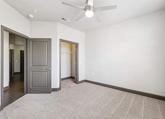 A room with a ceiling fan and a rug on the floor. at North Creek, Texas, 78634
