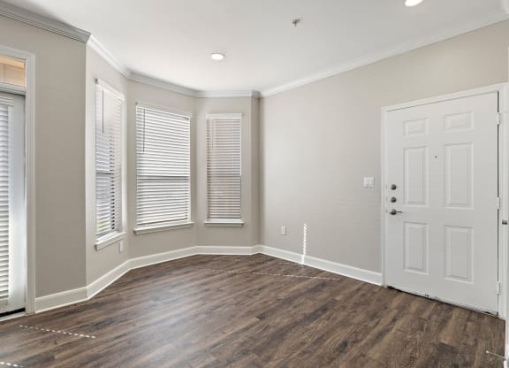 an empty living room with a white door and windows at The Verandah, Austin, TX, 78726