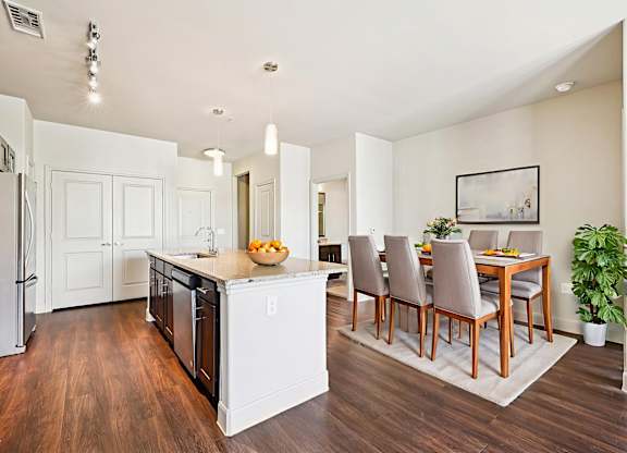 A kitchen with a dining table and chairs.at North Creek, Hutto, TX, 78634