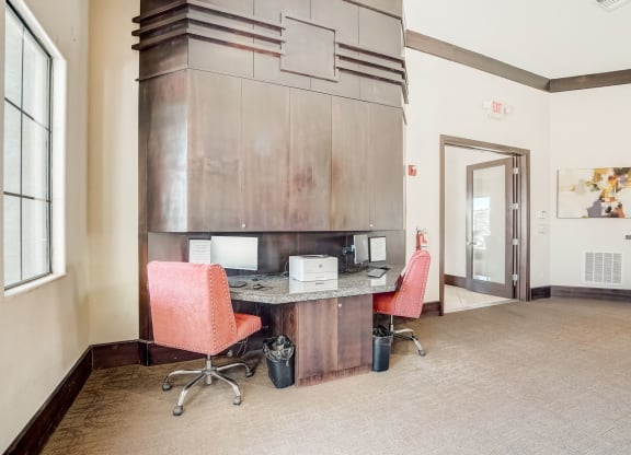 a conference room with two chairs and a desk with a microwave  at Adiamo Palm Valley, Goodyear, Arizona
