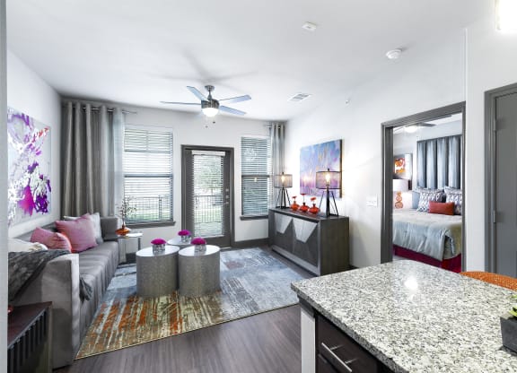 a living room with a kitchen and a bedroom at North Creek, Hutto, TX