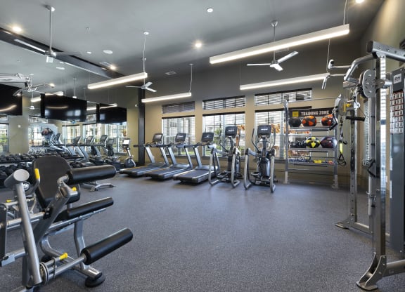 a gym with cardio equipment and weights on the floor at North Creek, Texas, 78634