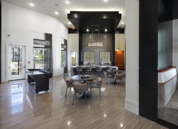 a dining room with tables and chairs and a bar in the corner at North Creek, Hutto, Texas