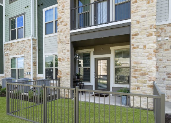 a metal fence in front of an apartment building at North Creek, Texas, 78634