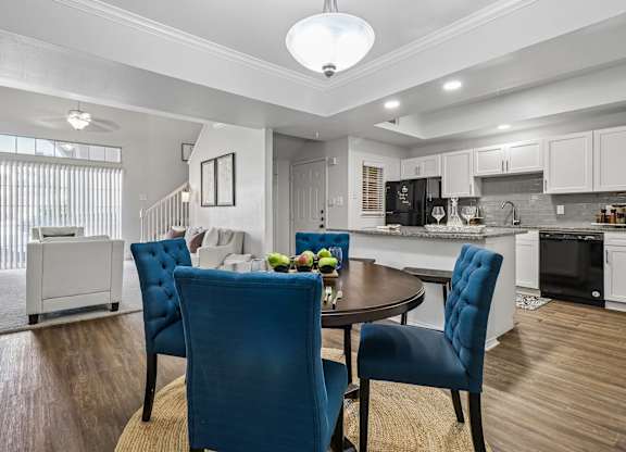 A modern kitchen with a dining table and chairs.