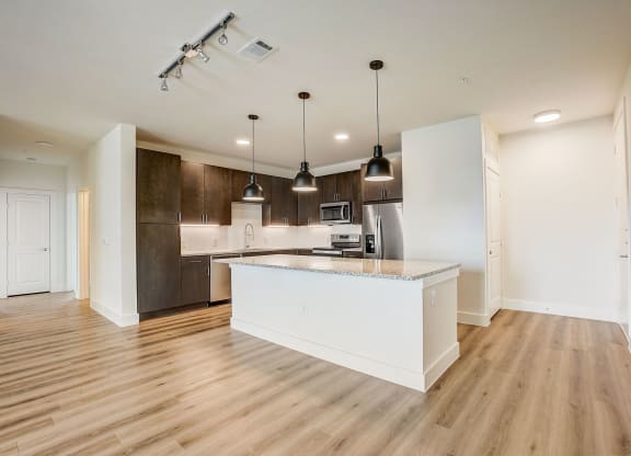 an open kitchen with a large island in the middle at Aurora Watson Branch, Mansfield, Texas