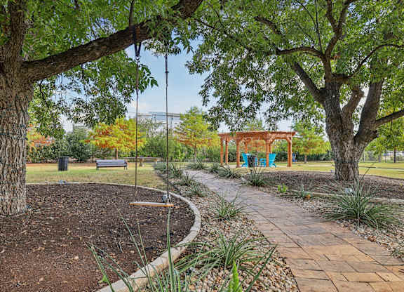 A park with a swing set and a bench.at North Creek, Texas, 78634
