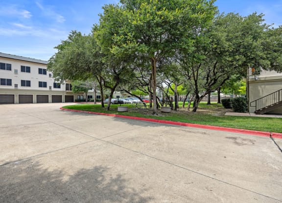 BBQ areas and mature trees at Artisan Apartments & Shops, Texas, 78729