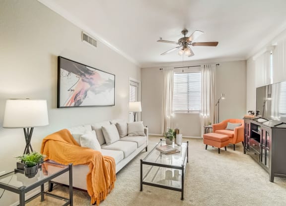 a living room with a white couch and a ceiling fan  at Adiamo Palm Valley, Arizona
