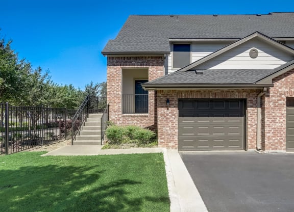 a house with a driveway and a garage door in front of it  at The Vista on Brodie, Austin, TX