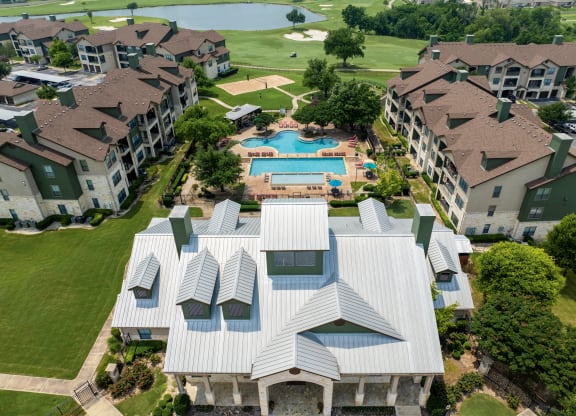 an aerial view of an apartment complex with a swimming pool