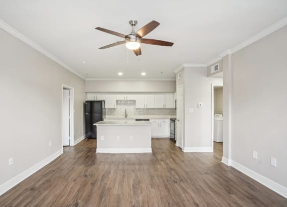 an empty living room and kitchen with a ceiling fan at The Verandah, Texas, 78726