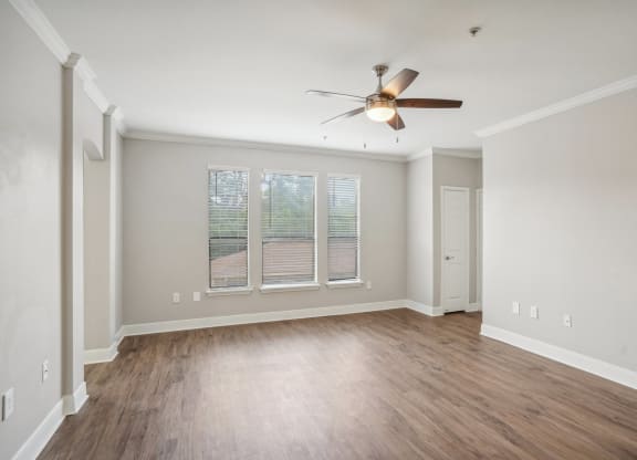 an empty living room with a ceiling fan and a window  at The Verandah, Austin, TX, 78726