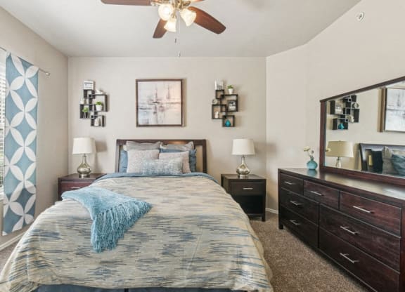 a bedroom with a bed and a ceiling fan
