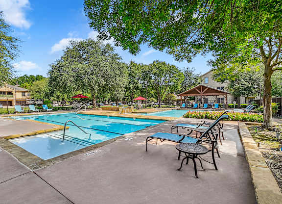 Pool With Lounge Chairs at The Canyons Apartments, Fort Worth, TX, 76116