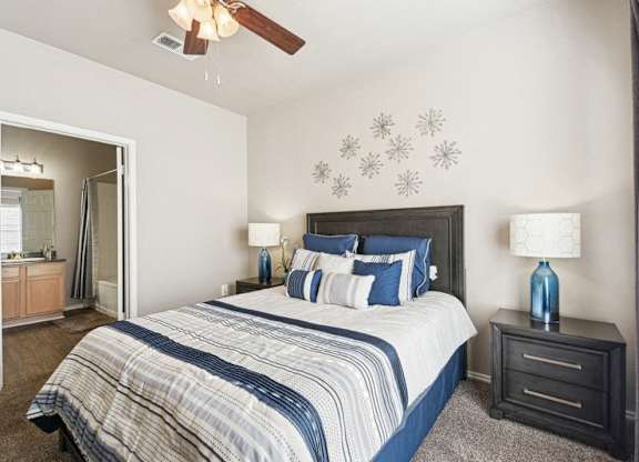 a bedroom with a bed and a ceiling fan