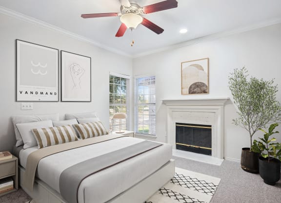 a bedroom with a bed and a fireplace at La Ventura Apartments, Plano, Texas