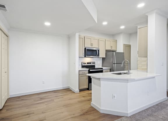 a white kitchen with a large island and a stainless steel at The Legends at Eagle Mountain Lake, Fort Worth, TX