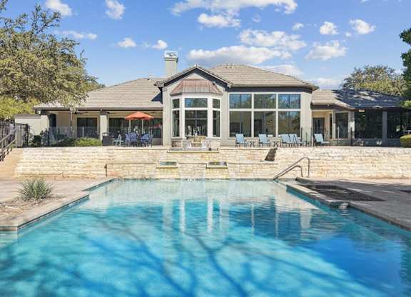 a pool with a house in the background