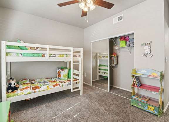 a bedroom with bunk beds and a ceiling fan