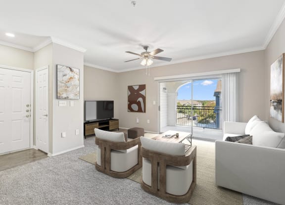 a living room with white furniture and a ceiling fan