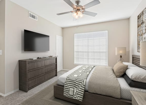 a bedroom with a large bed and a ceiling fan