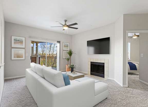a living room with a white couch and a ceiling fan at The Legends at Eagle Mountain Lake, Fort Worth, Texas
