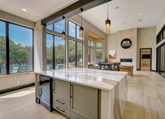 a large kitchen with a large island and large windows